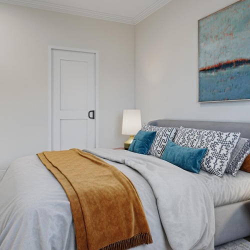 a bedroom with a bed and lamps